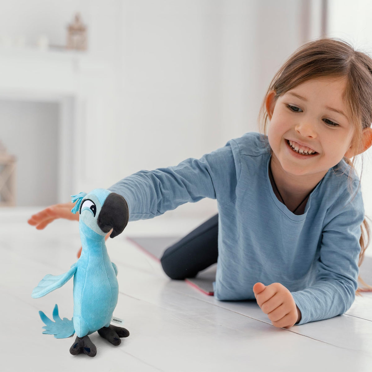 Adenzai Rio Jewel plush in hands shows portable companion for travel and cuddles.