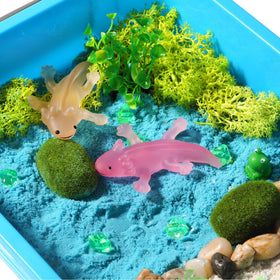 Axolotl figures with rocks create a tiny habitat scene