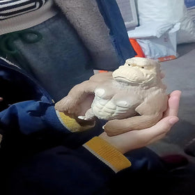 AHYCS brown gorilla stretch toy being squeezed for release.