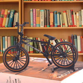 Ailejia metal toy bike features rotating pedals for tactile, relaxing play.