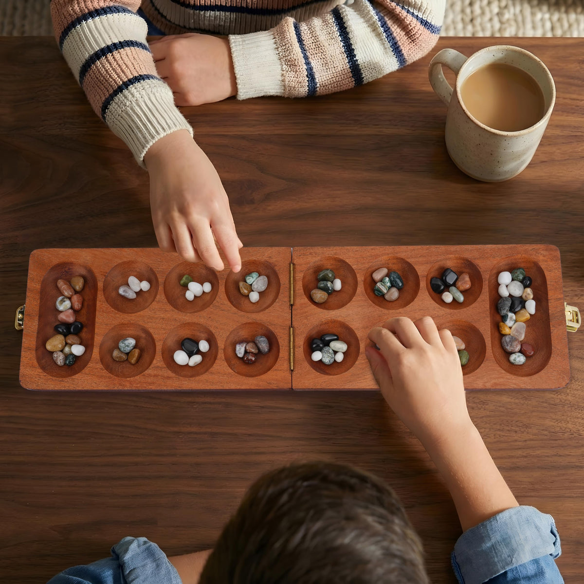 Ajuny Mancala board with clear instructions for quick setup