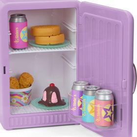Four colorful soda cans with teal plates for a party setting.
