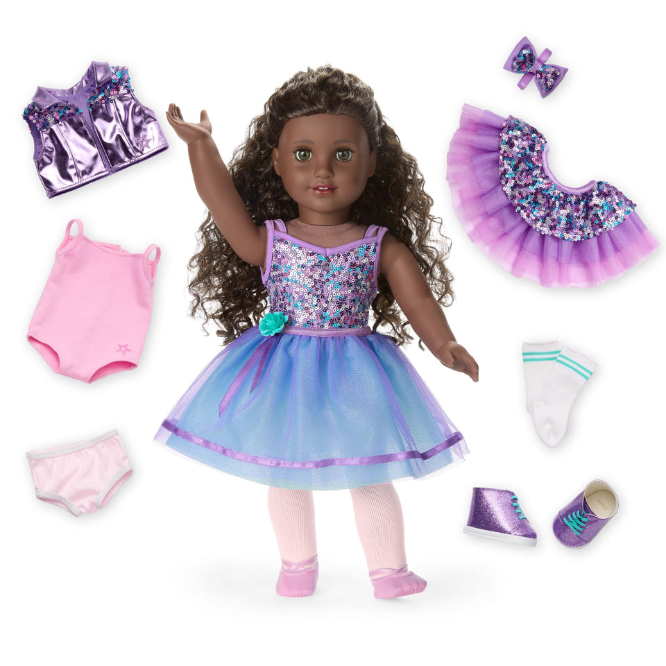 American Girl Truly Me 127 doll with hazel eyes and curly dark-brown hair ready for dance.