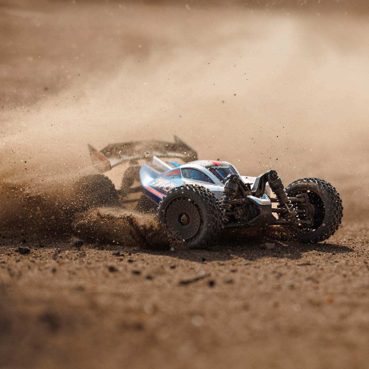 ARRMA Typhon GROM 4x4 rear view emphasizes rugged chassis and stability on rough surfaces.