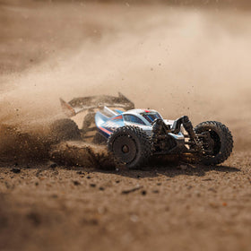 ARRMA Typhon GROM 4x4 rear view emphasizes rugged chassis and stability on rough surfaces.