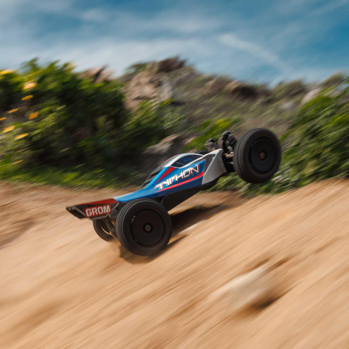 ARRMA Typhon GROM 4x4 suspension close-up shows oil-filled shocks for smooth handling.