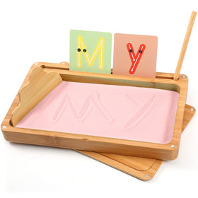AtMini Montessori sand tray with pink sand and lid for handwriting practice.