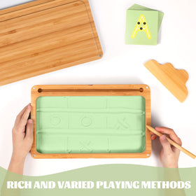 AtMini sand tray with green sand supports letter-writing play.