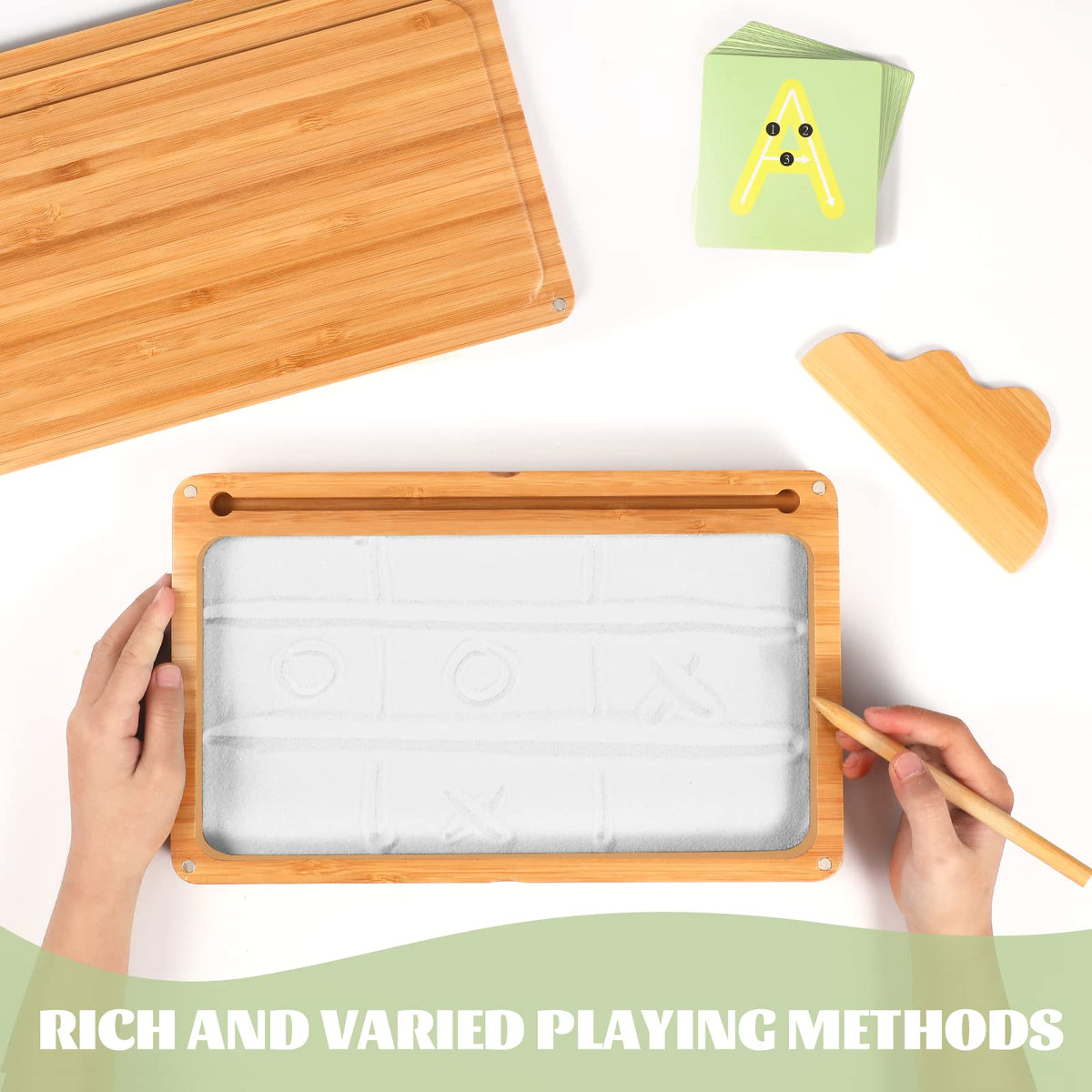AtMini sand tray white sand inviting sensory tracing and creativity.