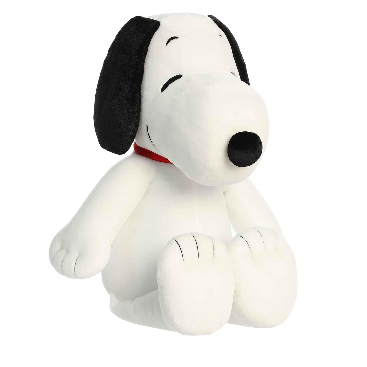 Aurora Adorable Peanuts Jumbo Floppy Snoopy plush resting on a bed for cozy nostalgia.