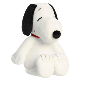 Aurora Adorable Peanuts Jumbo Floppy Snoopy plush resting on a bed for cozy nostalgia.