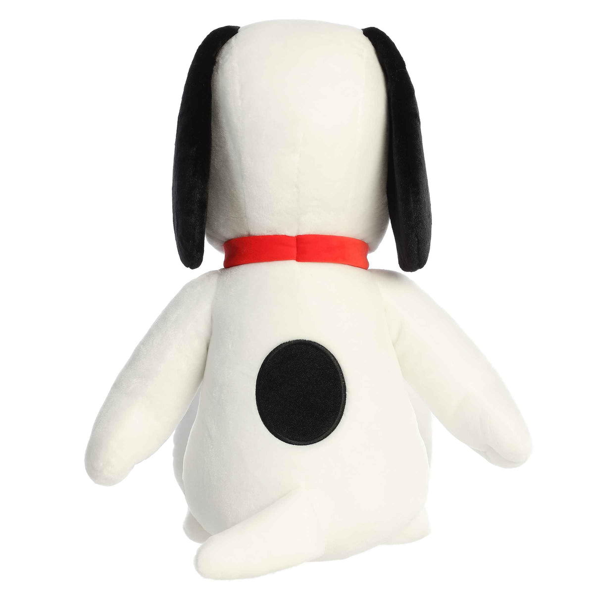 Aurora Jumbo Floppy Snoopy plush on a sofa for playful home decor.