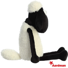 Close-up of textured cream fur and friendly eyes on the Aurora Shaun plush.