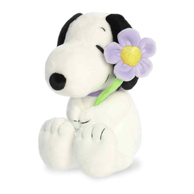 Aurora Snoopy plush holding a purple flower, 9-inch spring decor for shelves and gifts.