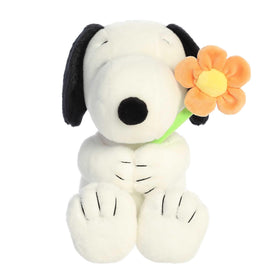 Aurora Snoopy plush with flower close-up highlights soft texture.