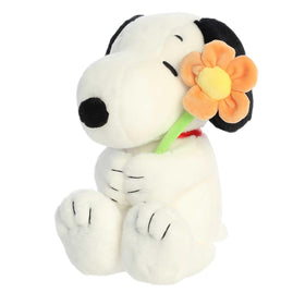 Aurora Timeless Peanuts Snoopy plush with flower, front view ready for cuddles.