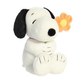 Snoopy plush by Aurora with flower showcases cheerful, gift-worthy detail.