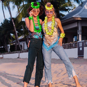Aviski party scene featuring leis and tropical decor under sun