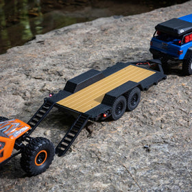 Axial SCX24 trailer hitch and ramps enable quick loading of cars.