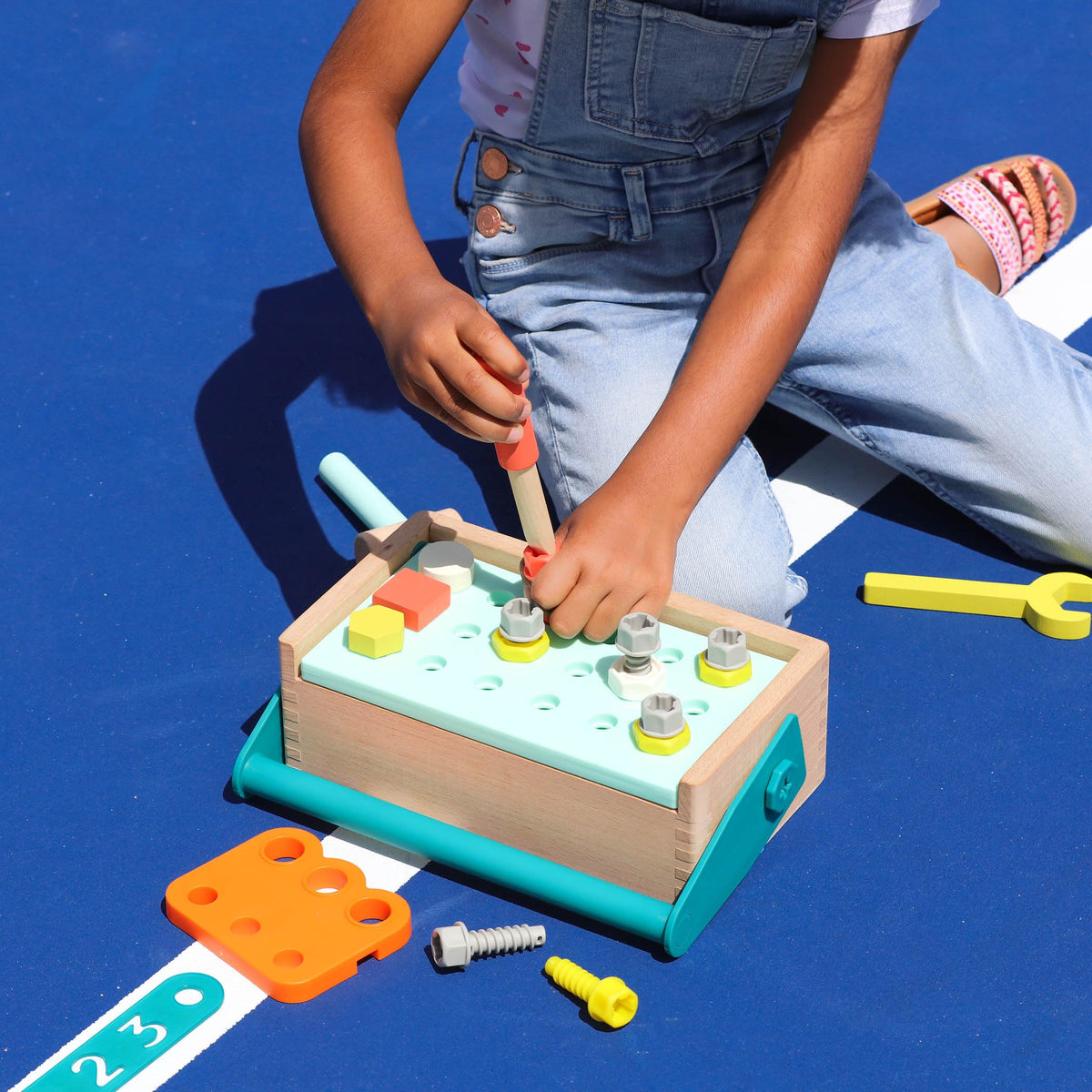 B. toys Fix-n-Play Kit drill in action for imaginative building sessions.