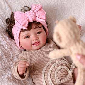 BABESIDE Mia 17-inch curls and pink bow add realism and charm