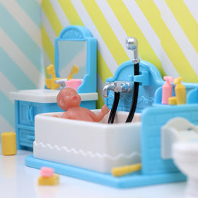 BABESIDE tiny blue silicone baby doll in hand for portable playtime