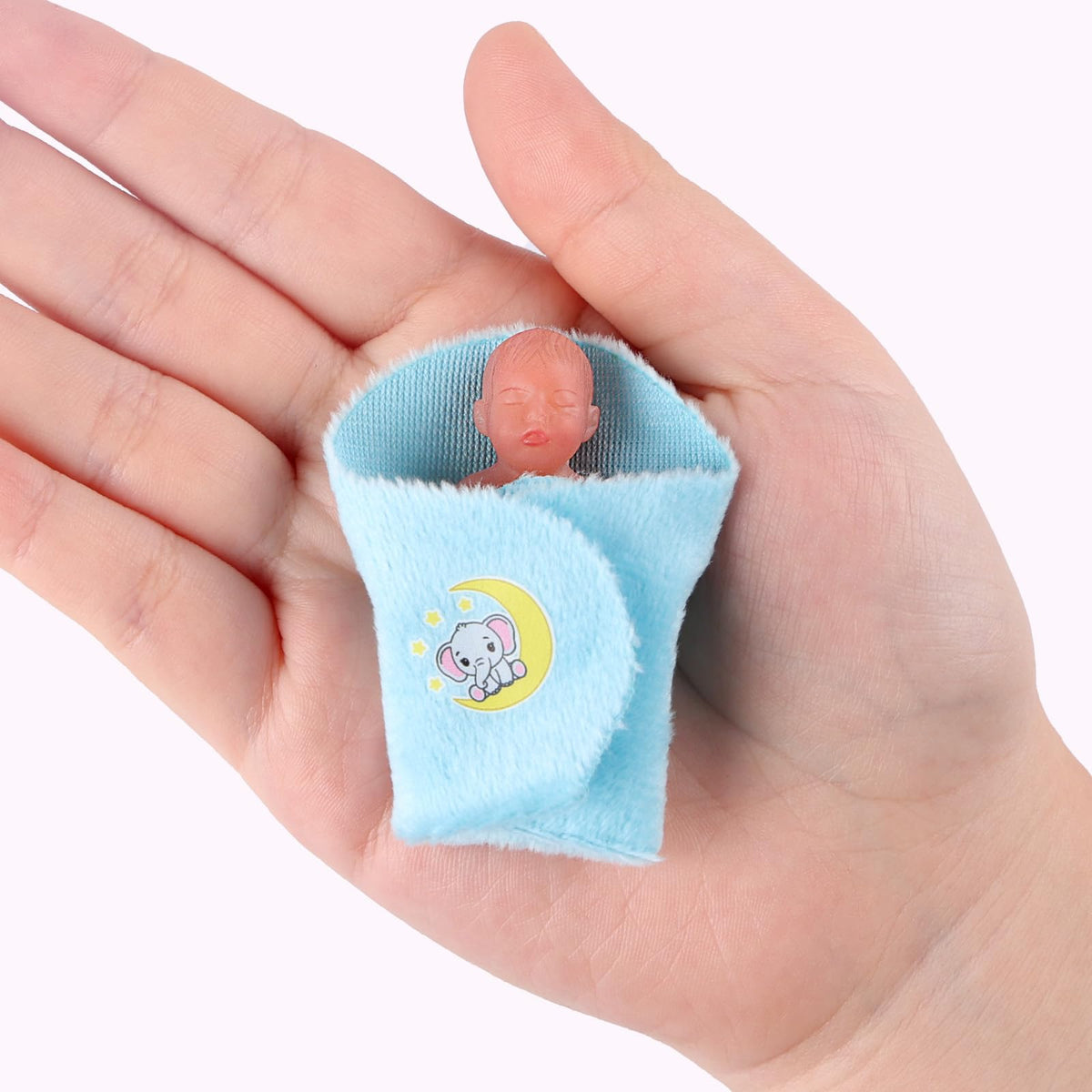 BABESIDE blue swaddle mini doll demonstrates cozy newborn-style comfort during pretend care