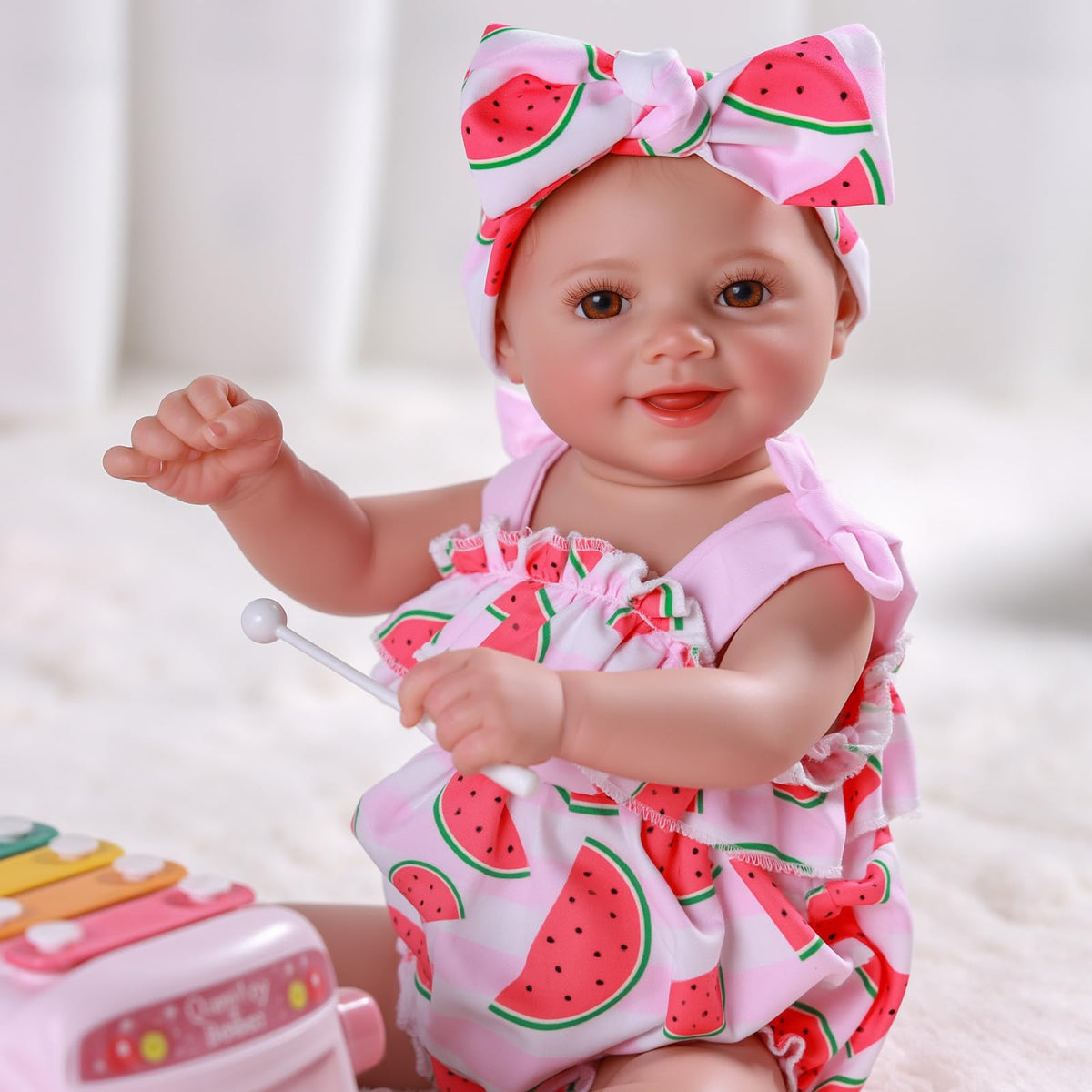 BABESIDE Sunny doll in hand demonstrates kid-friendly, portable size for travel