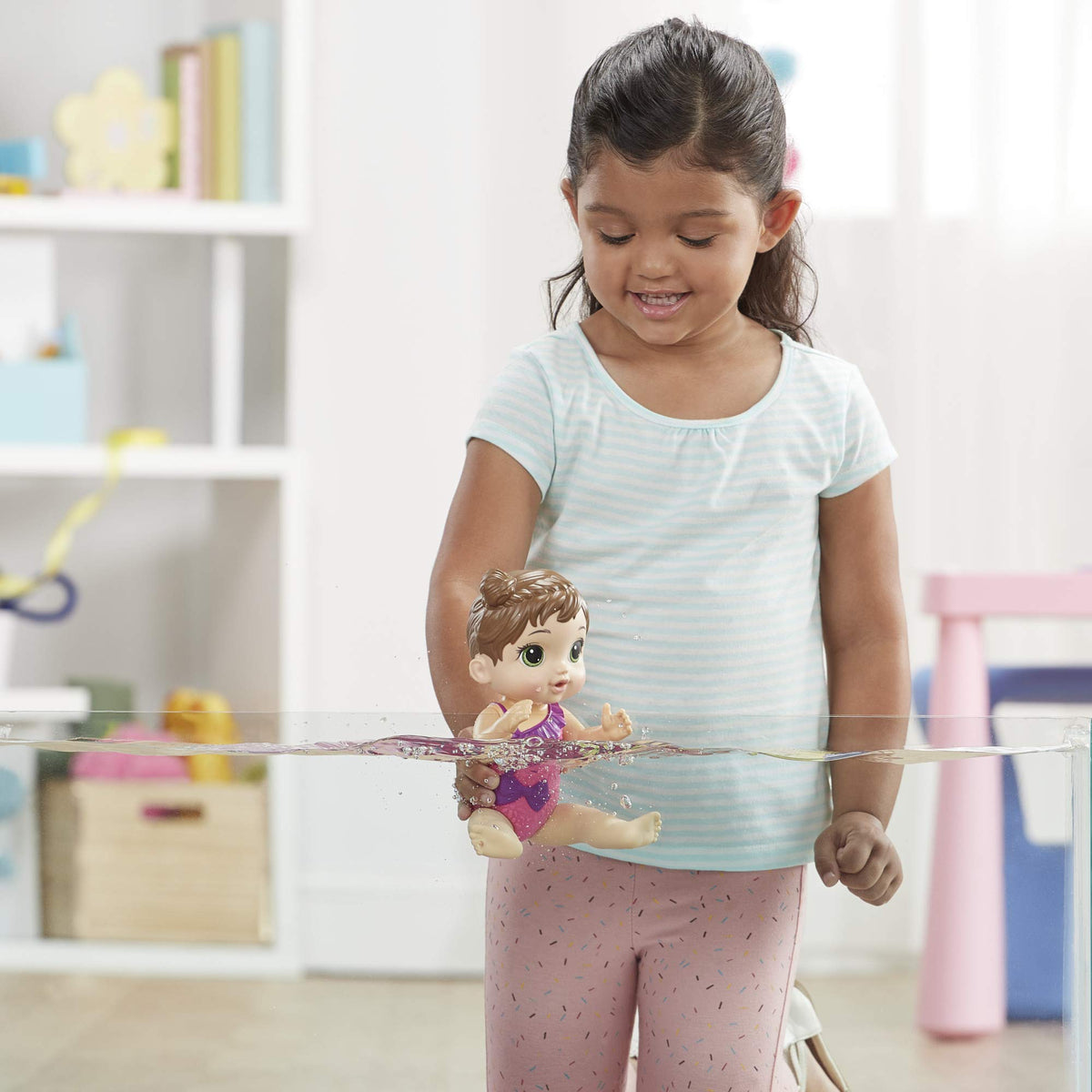 Gift-ready Baby Alive Splash'n Snuggle set with doll and accessories in packaging.