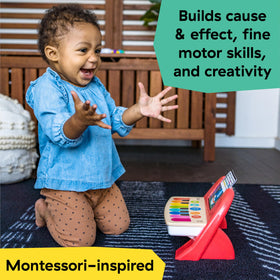 Baby Einstein Cal's First Melodies Magic Touch surface tapped by tiny hands for responsive music creation