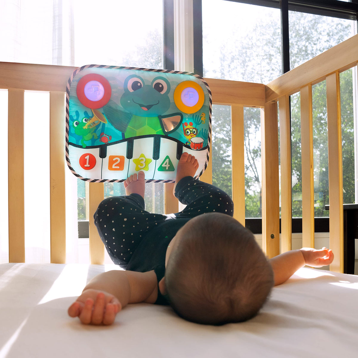 Baby Einstein crib attachment converts to floor toy for tummy time.