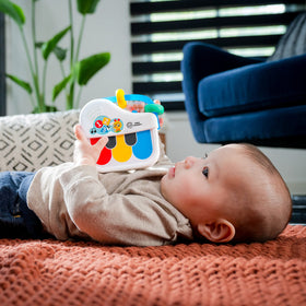 Baby Einstein bead chasers on tiny hands during play