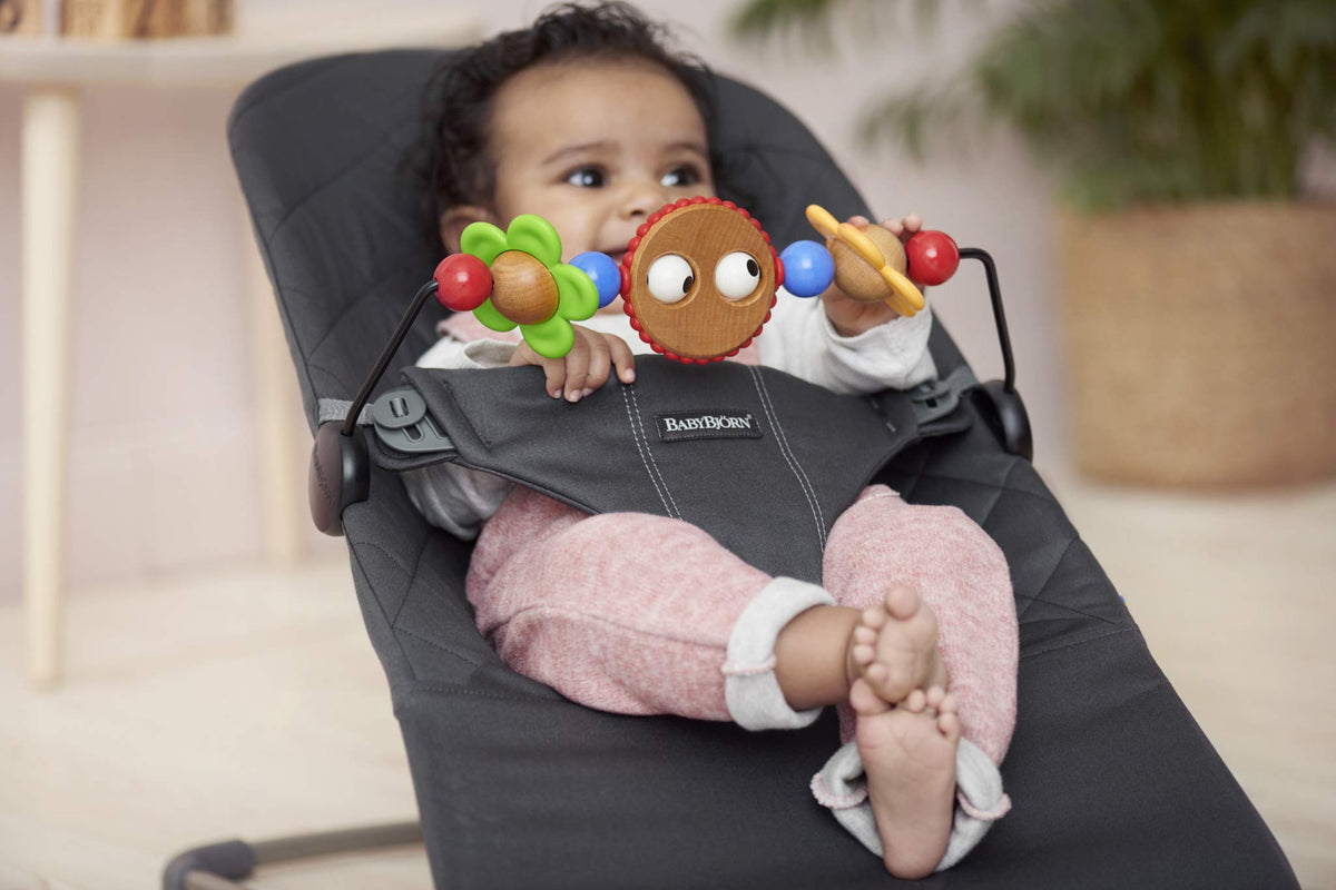 BabyBjörn Googly Eyes toy colors invite grasping and sensory exploration on the Bouncer.
