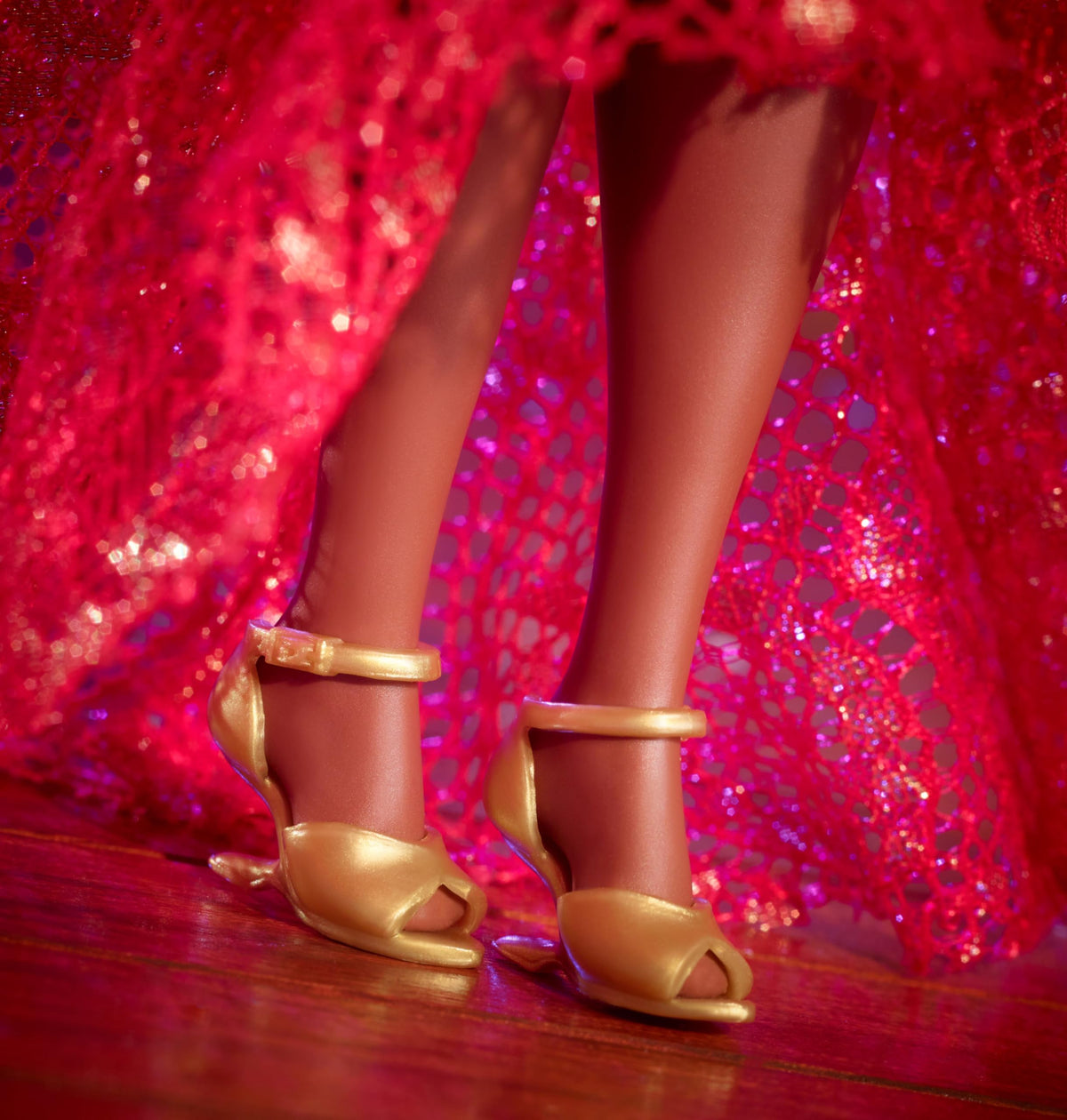 Barbie Celia Cruz doll stand supports elegant display.