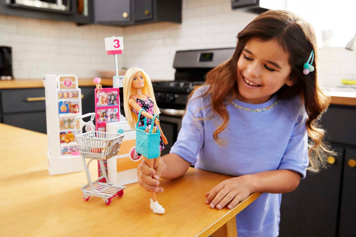 Barbie checkout stand with conveyor belt enables pretend checkout and storytelling.
