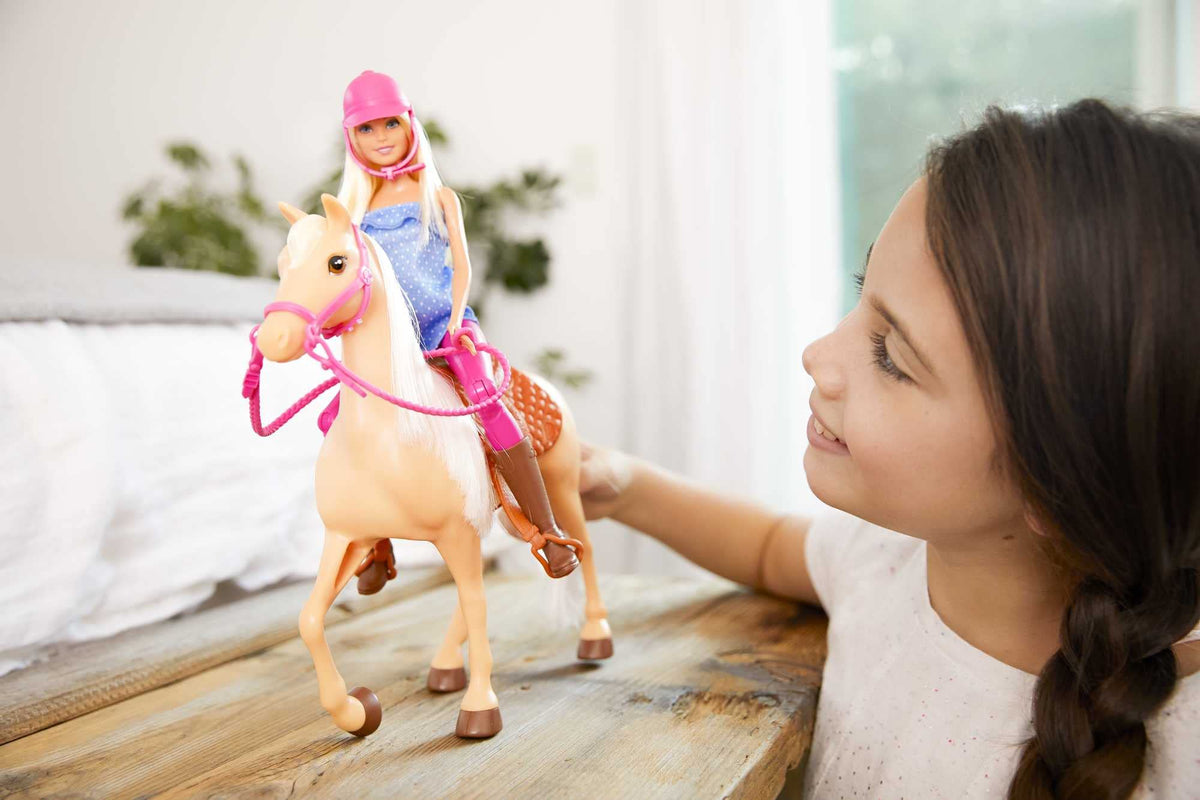 Barbie wearing riding outfit and pink helmet for adventurous dress-up play