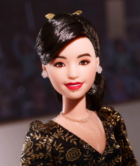 Barbie Inspiring Women Kristi Yamaguchi with gold ribbon in hair for iconic moment recreation