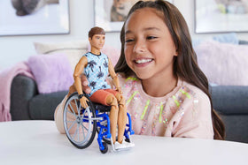 Barbie Ken's wheelchair and green ramp enable easy access to the Dreamhouse playset.