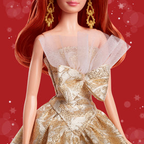 Barbie Signature doll featuring gold drop earrings for authentic sparkle.