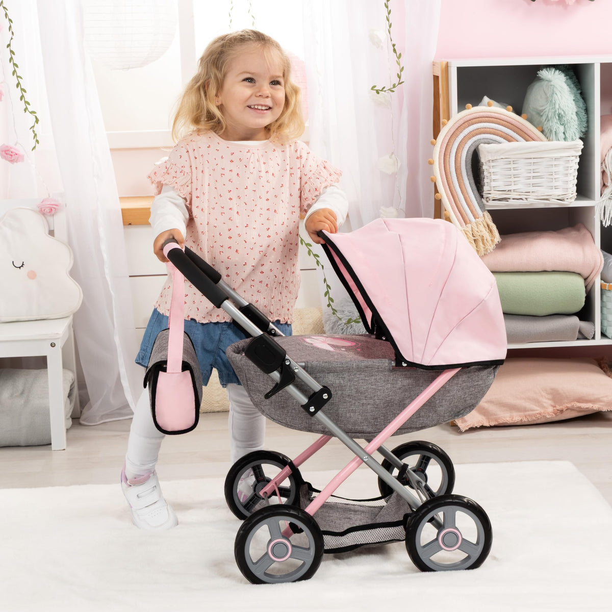 Cozy blanket and pillow accompany Bayer stroller for comforting pretend care.