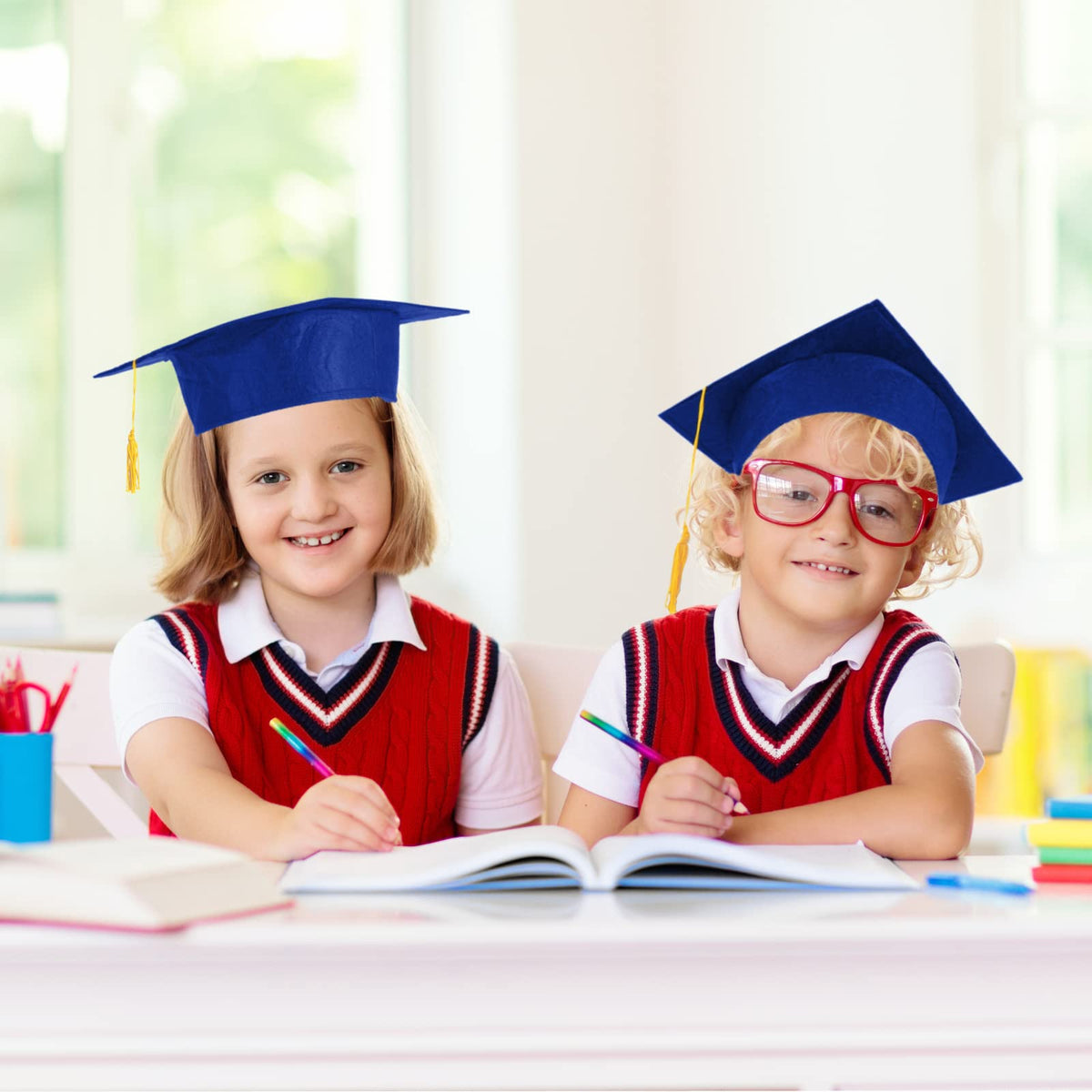 Children wearing BeapTcely blue grad cap for milestone photos
