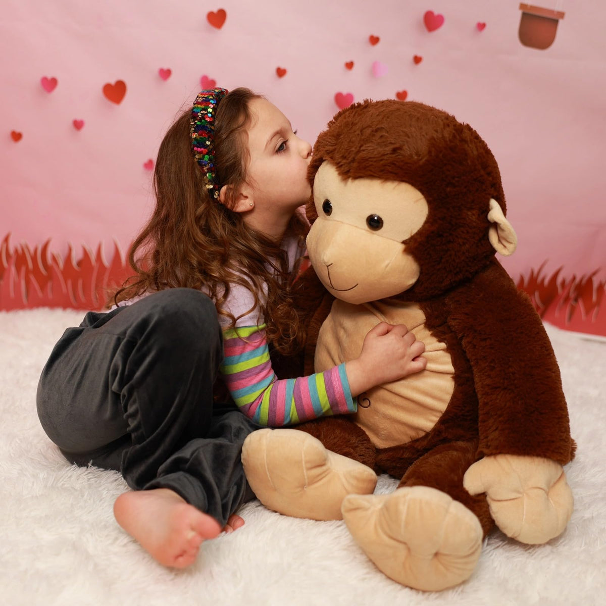 BENINY 30-inch giant plush monkey lying on bed, cozy seating and decor.