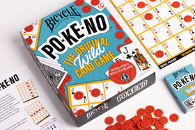Family playing Bicycle Pokeno at table enjoying a lively session.