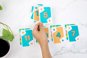 Bidson Games Poof The Game cards on table ready for discard and twist