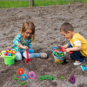 BIRANCO toddler holds a flower stem, boosting fine motor skills and confidence.
