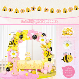 Birhgt yellow-pink yarn pom decor creates soft, fluffy accents for photo-worthy corners.