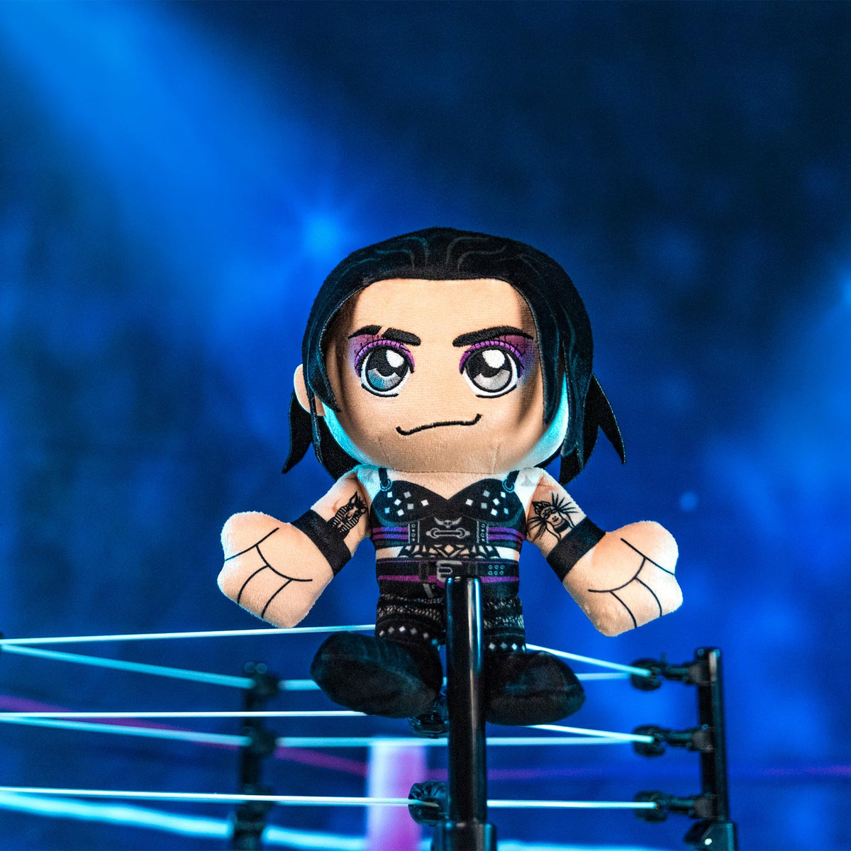 Rhea Ripley Kuricha plush, textured fabric close-up highlights durable stitching.