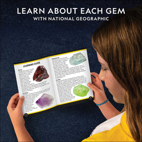 Blue Marble National Geographic dig kit reveals aquamarine gemstone with magnification.