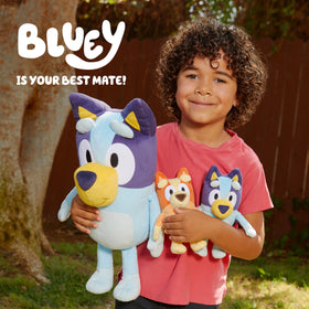 Bluey plush beside a backpack, ideal for travel adventures.