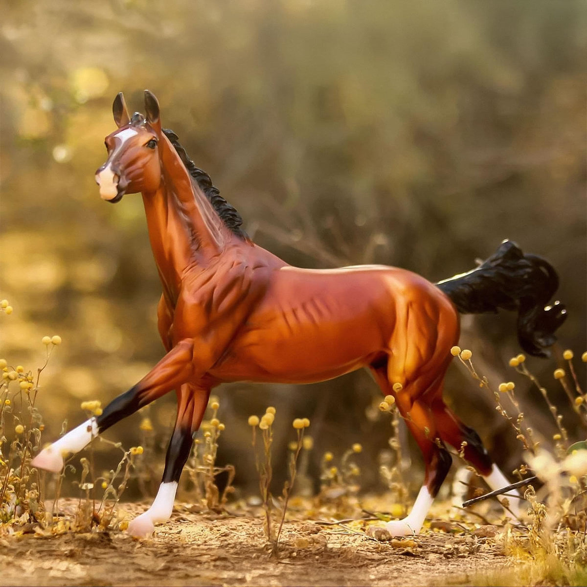 Breyer Adamek Akhal-Teke figure in dressage pose suggests dynamic play.